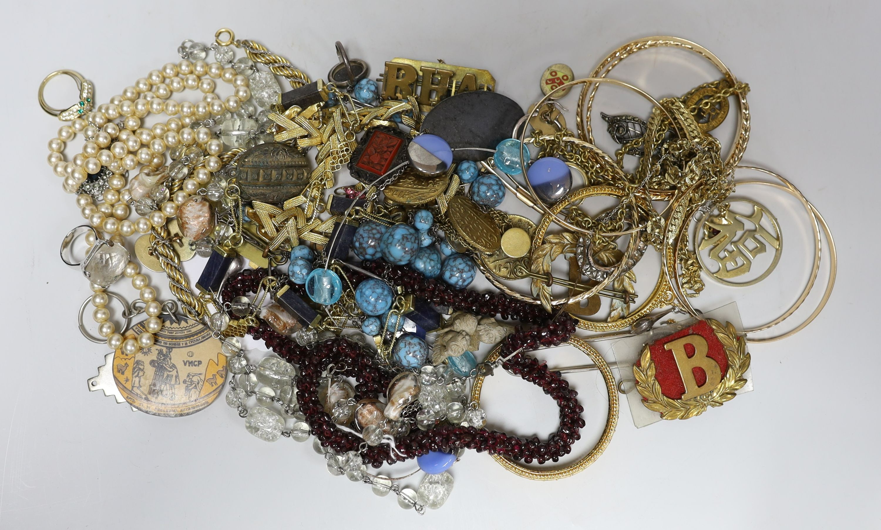 A quantity of assorted costume jewellery and other items including silver and enamel plaque and a garnet bead necklace.